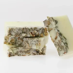 Three pieces of herbal soap with natural ingredients.