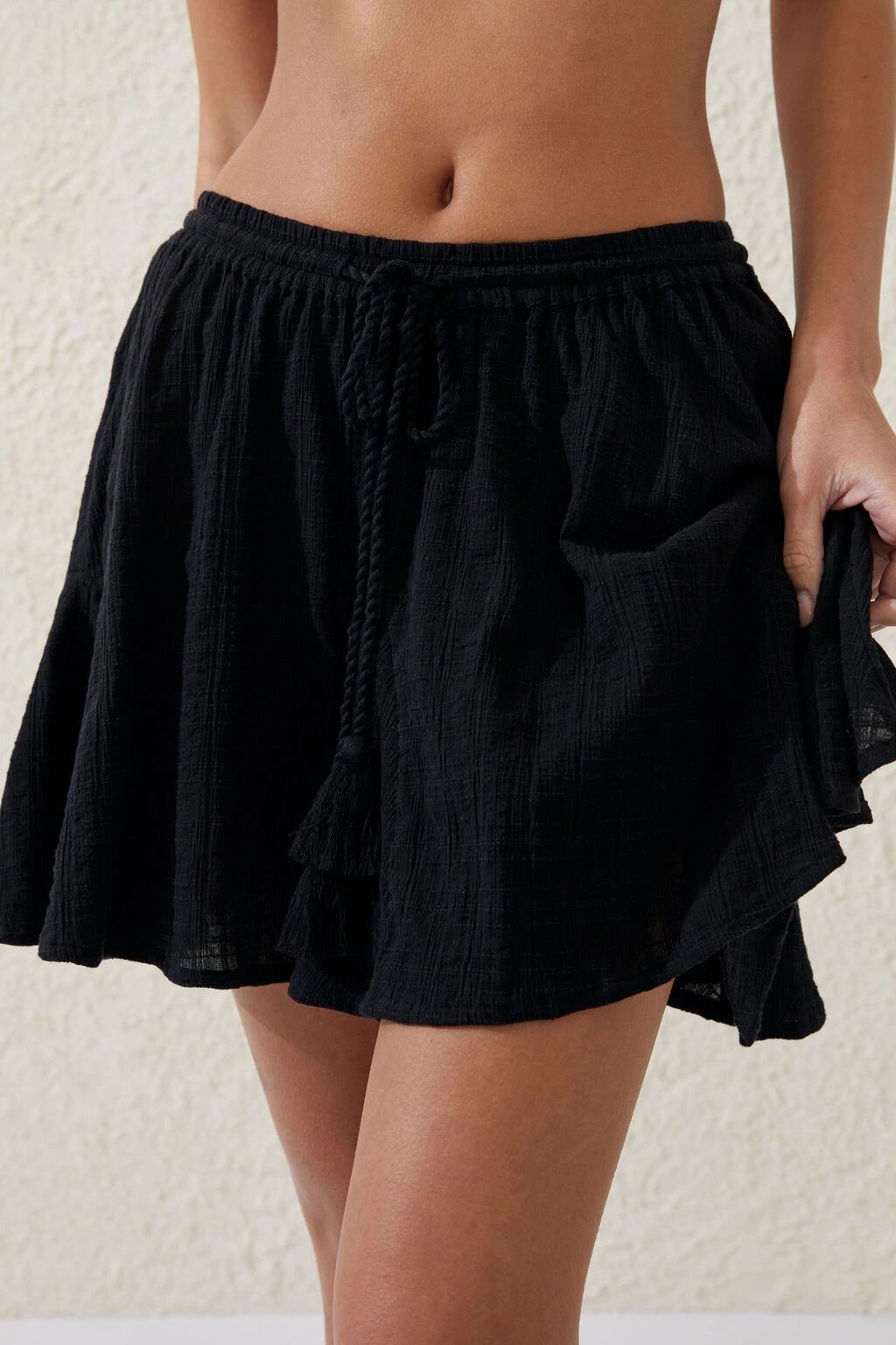 Black casual skirt with a pocket detail, worn by a person.