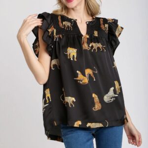 Black blouse with animal prints and ruffled sleeves.