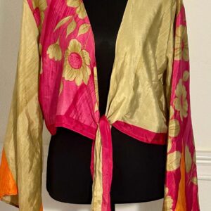 A vibrant silk scarf with golden floral patterns and pink borders.