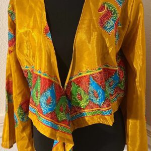 Colorful, patterned yellow jacket with a draped front.