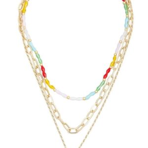 Layered gold necklace with colorful beads and chains.