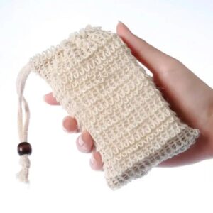 Hand holding a beige crocheted pouch with a drawstring.