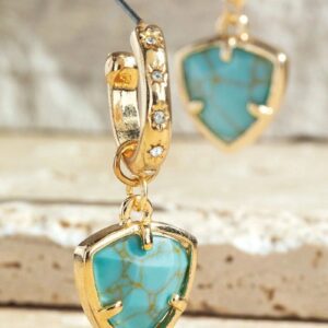 Gold earrings with turquoise heart-shaped stones and diamond accents.