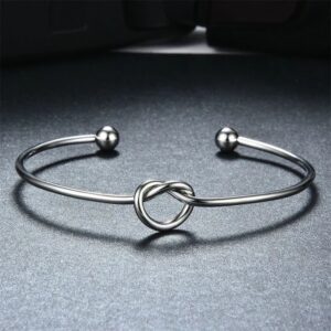 Silver bracelet with a heart-shaped knot design.
