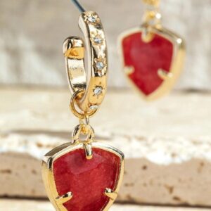 Gold earrings with red heart-shaped pendants.
