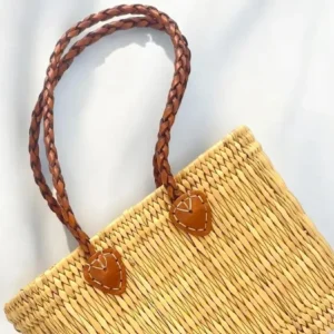 Woven straw tote bag with braided leather handles.