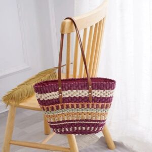 Handwoven striped tote bag hanging on a wooden chair.