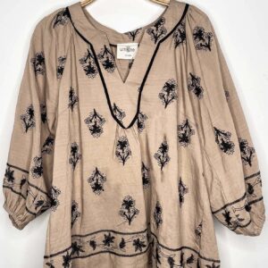 Beige blouse with black floral patterns and 3/4 sleeves.