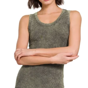 Woman in a sleeveless gray top with arms crossed.