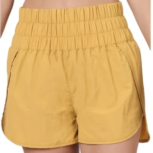 Yellow elastic waist shorts on a person.